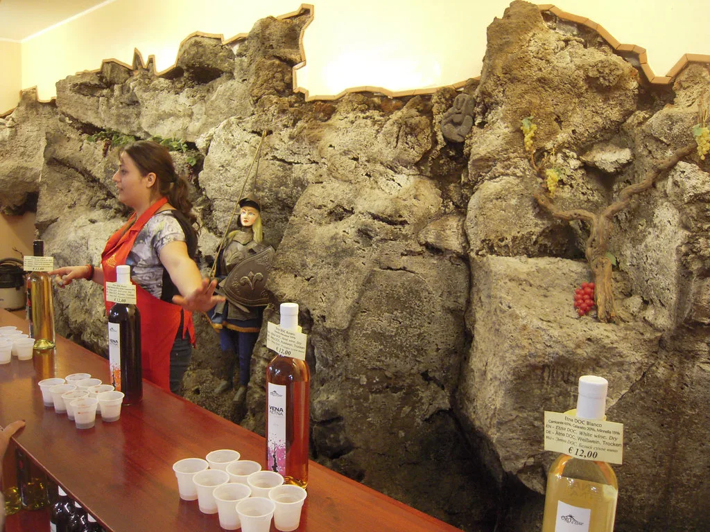 A tasting set up in front of a preserved lava wall at a winery in Zafferana Etnea, on Etna's eastern slope