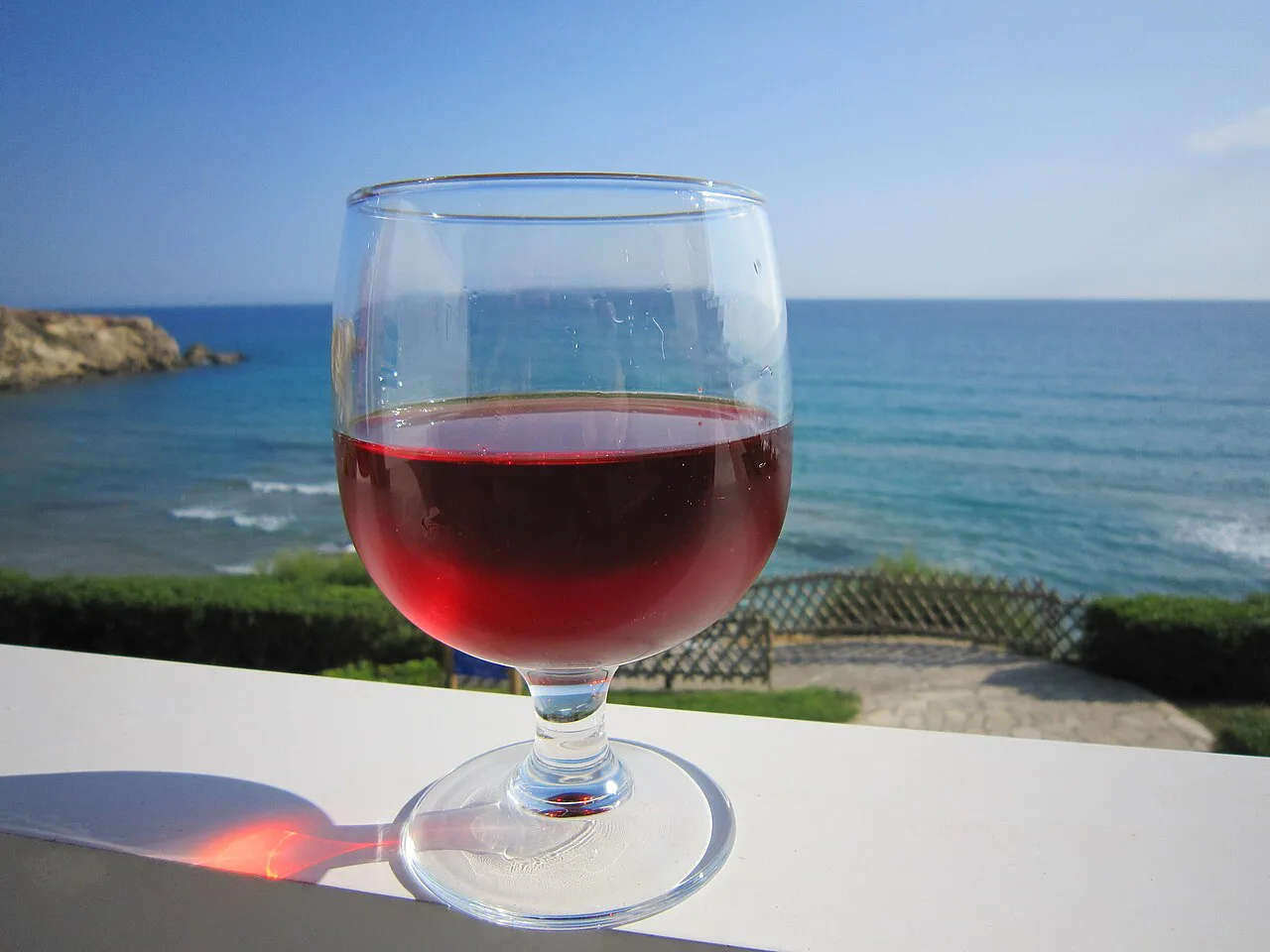 A glass of Cretan rosé by the sea