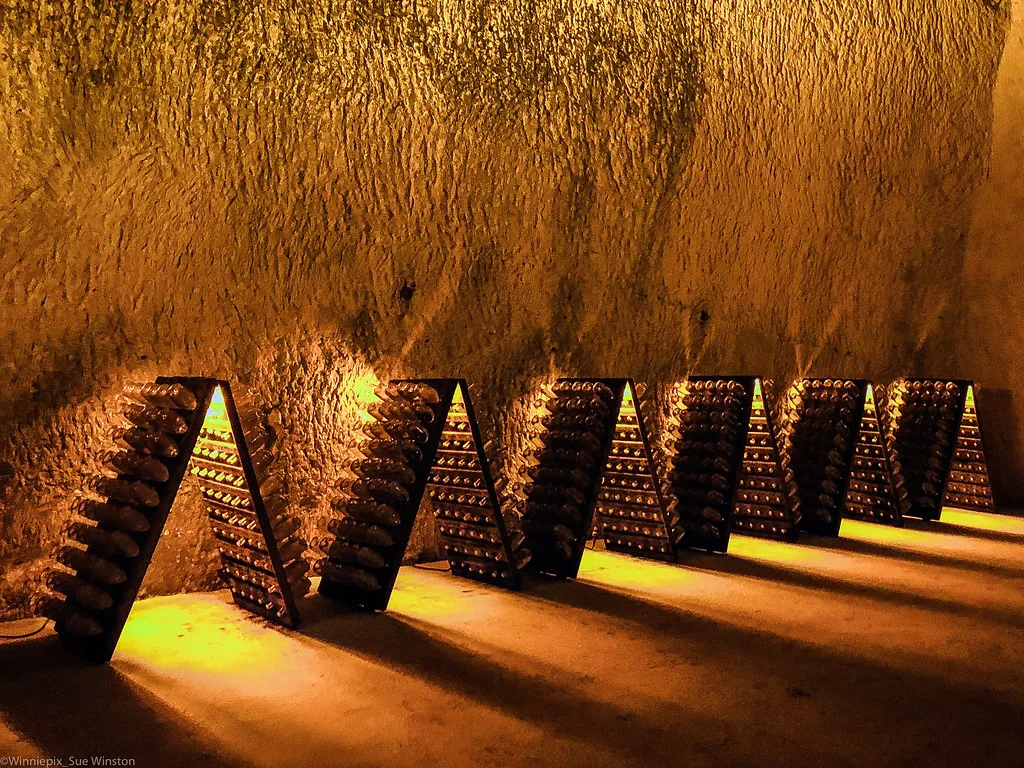 Riddling racks full of Ruinart champagne in their crayeres, Reims, France