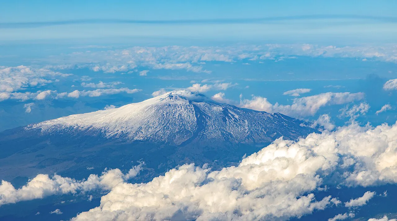 Snow-capped Etna above the clouds